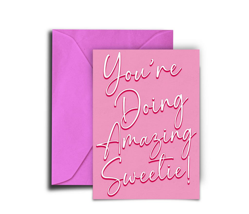 Pink card with 'You're Doing Amazing Sweetie!' text and a matching pink envelope on a white background